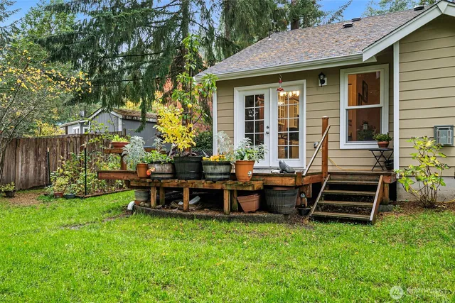 a view of a house with a backyard and chairs
