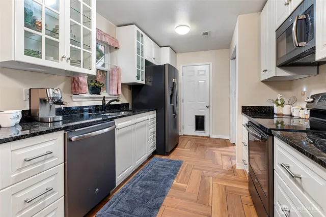 a kitchen with stainless steel appliances granite countertop a stove and a refrigerator