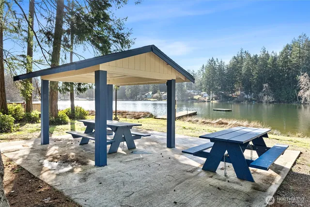 a view of a house with pool and sitting area