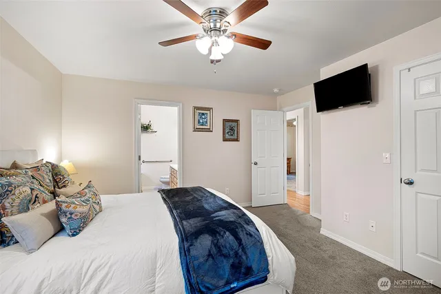 a bedroom with a bed and a flat screen tv