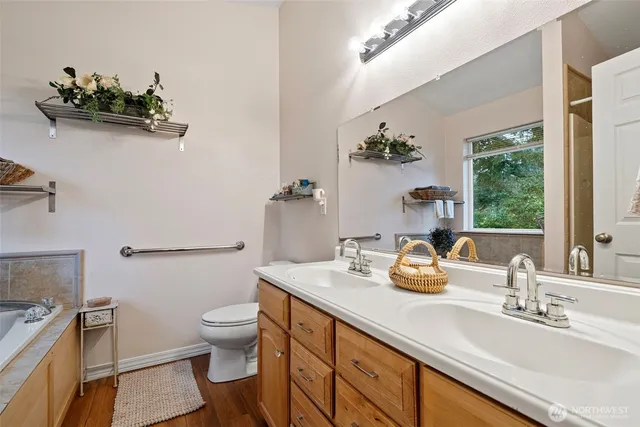 a bathroom with a sink a toilet and a mirror