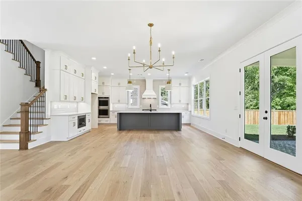 an empty room with wooden floor and closet