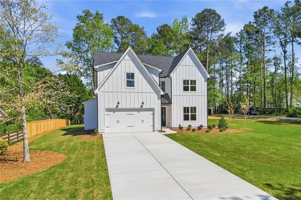 a large kitchen with kitchen island a sink stainless steel appliances and a large window
