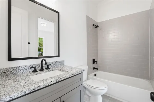a bathroom with a bathtub and toilet