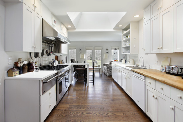 1111 Sunset Road Winnetka, IL 60093 - Photo 6 of 12 a kitchen with stainless steel appliances a sink window and cabinets