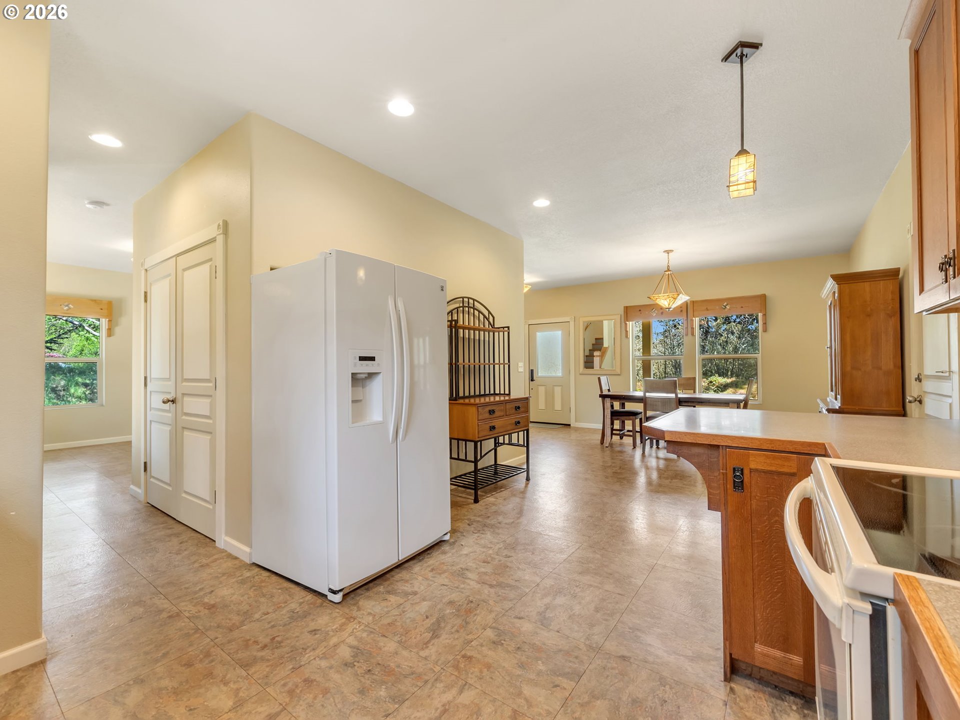 1077 Southwest Ridge Road Warrenton, OR 97146 - Photo 17 of 46 a view of a kitchen with refrigerator and furniture