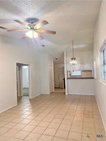 a view of a kitchen with a sink and chandelier