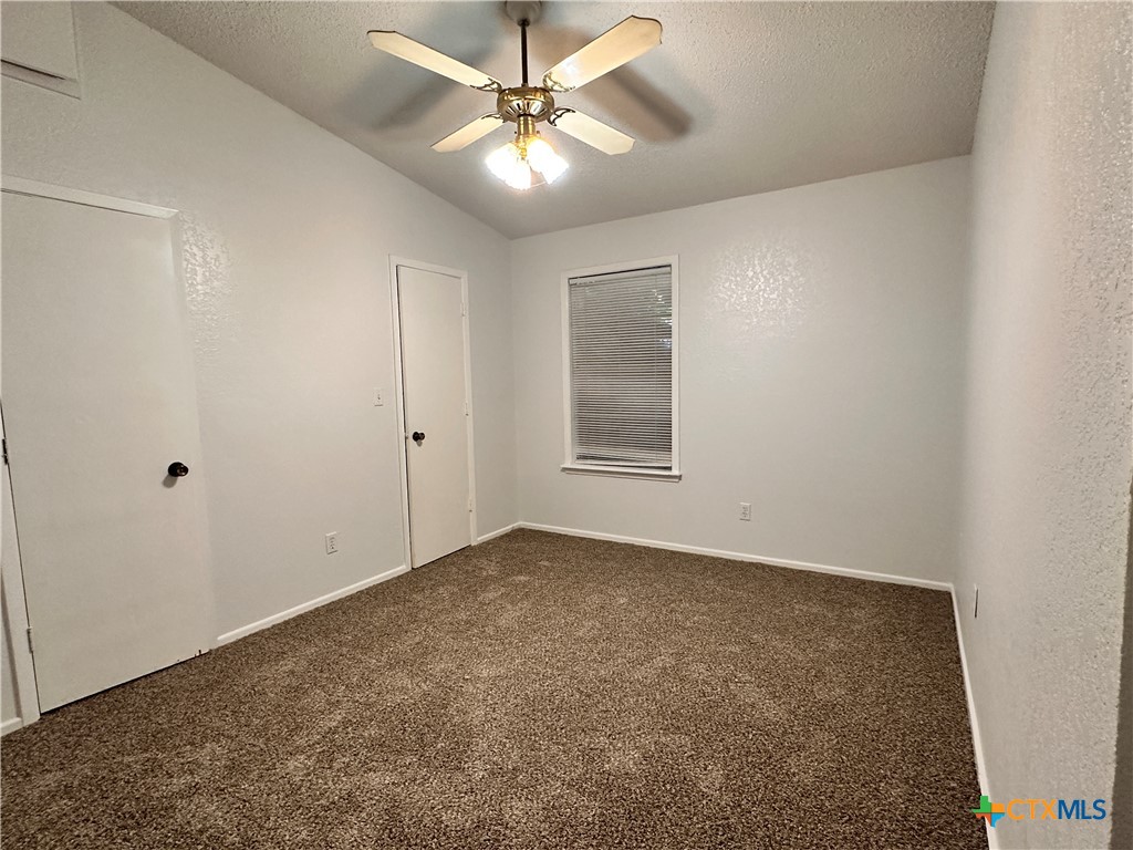 614 Mill Street, Unit B San Marcos, TX 78666 - Photo 12 of 16 an empty room with windows and fan