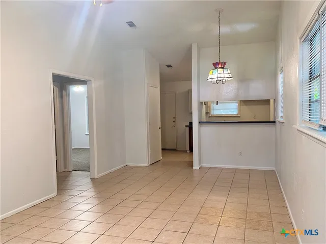 a view of a room with wooden floor and window
