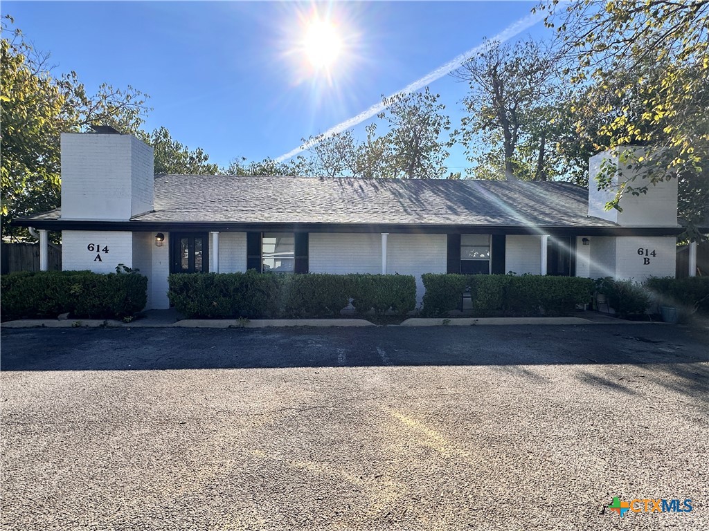 614 Mill Street, Unit B San Marcos, TX 78666 - Photo 5 of 16 a front view of a house with a yard