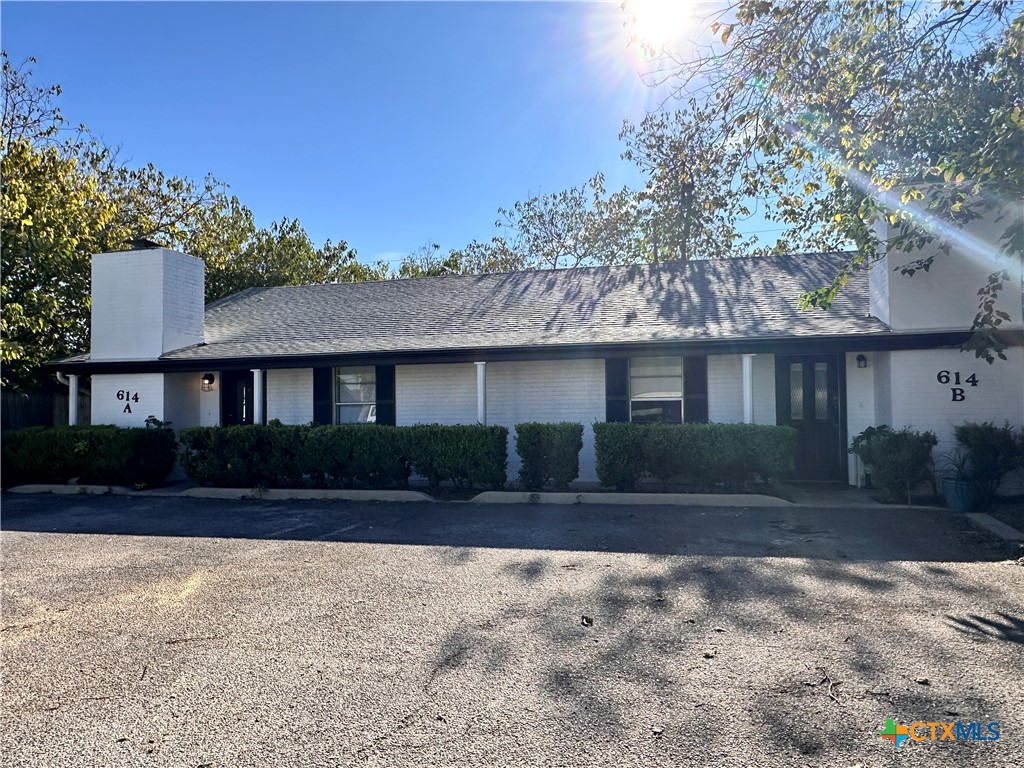 614 Mill Street, Unit B San Marcos, TX 78666 - Photo 6 of 16 a front view of a house with a yard