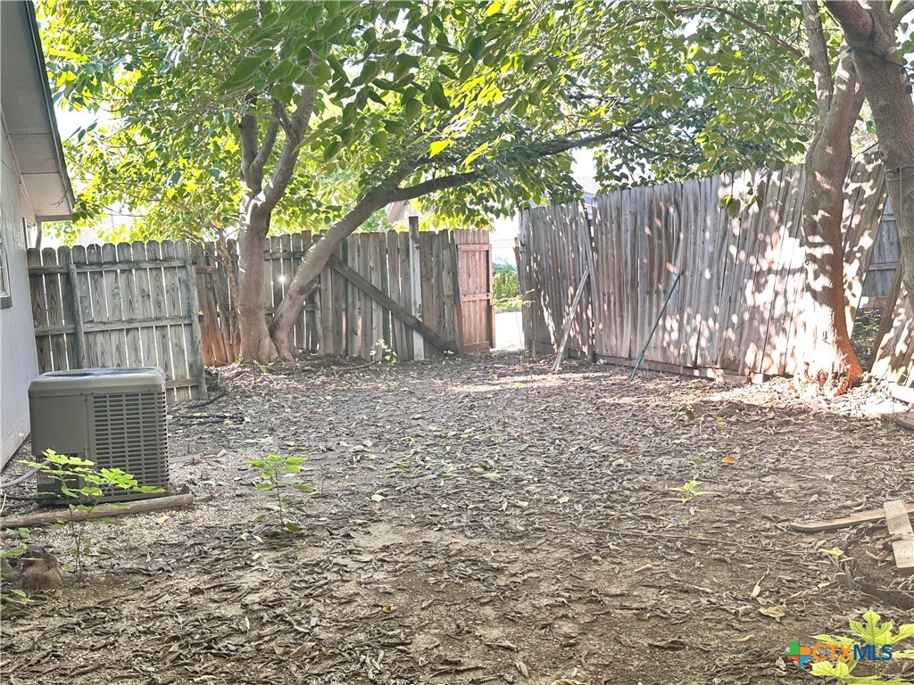 614 Mill Street, Unit B San Marcos, TX 78666 - Photo 8 of 16 a view of a house with a small yard and large tree