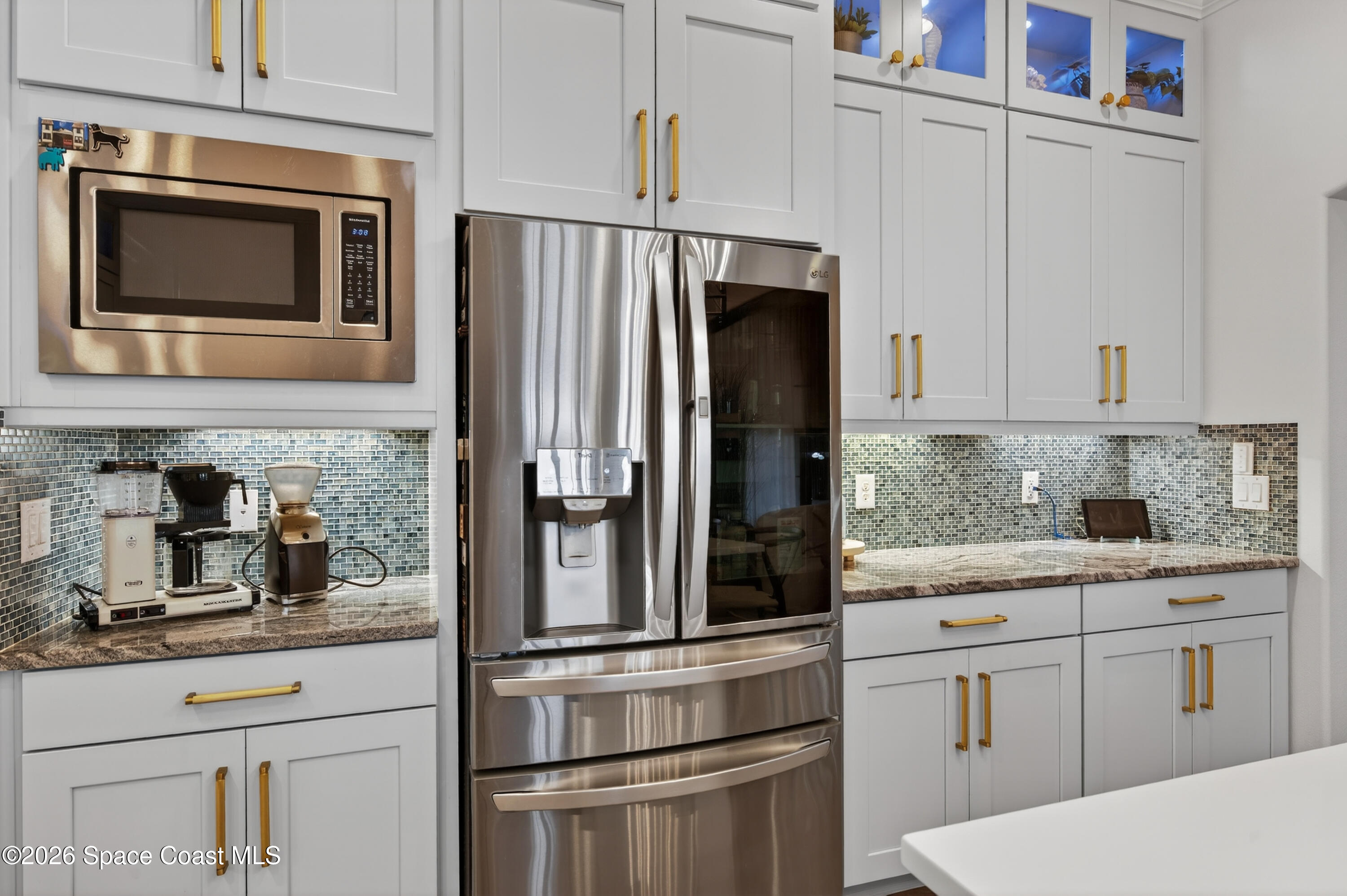 a kitchen with appliances a sink and cabinets