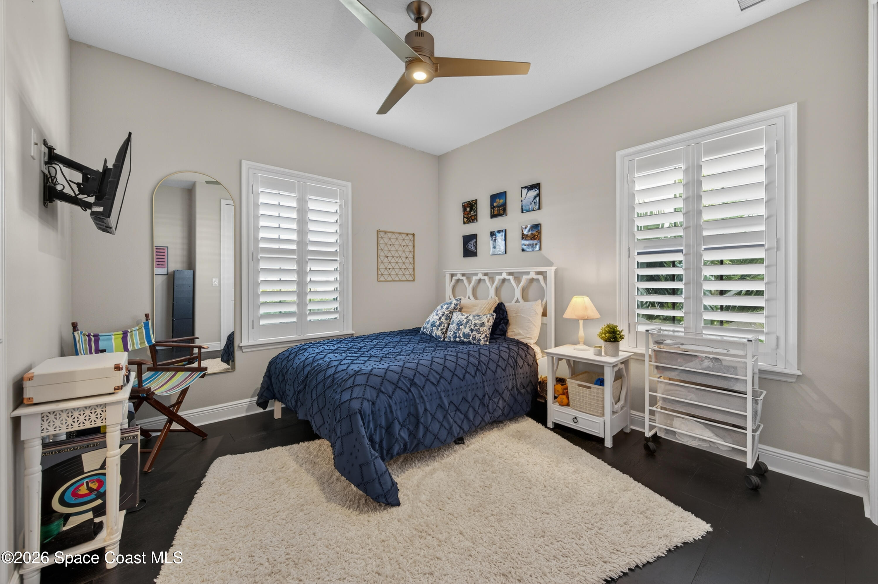 2343 Rodina Drive Melbourne, FL 32940 - Photo 19 of 72 a bedroom with a bed and a chandelier