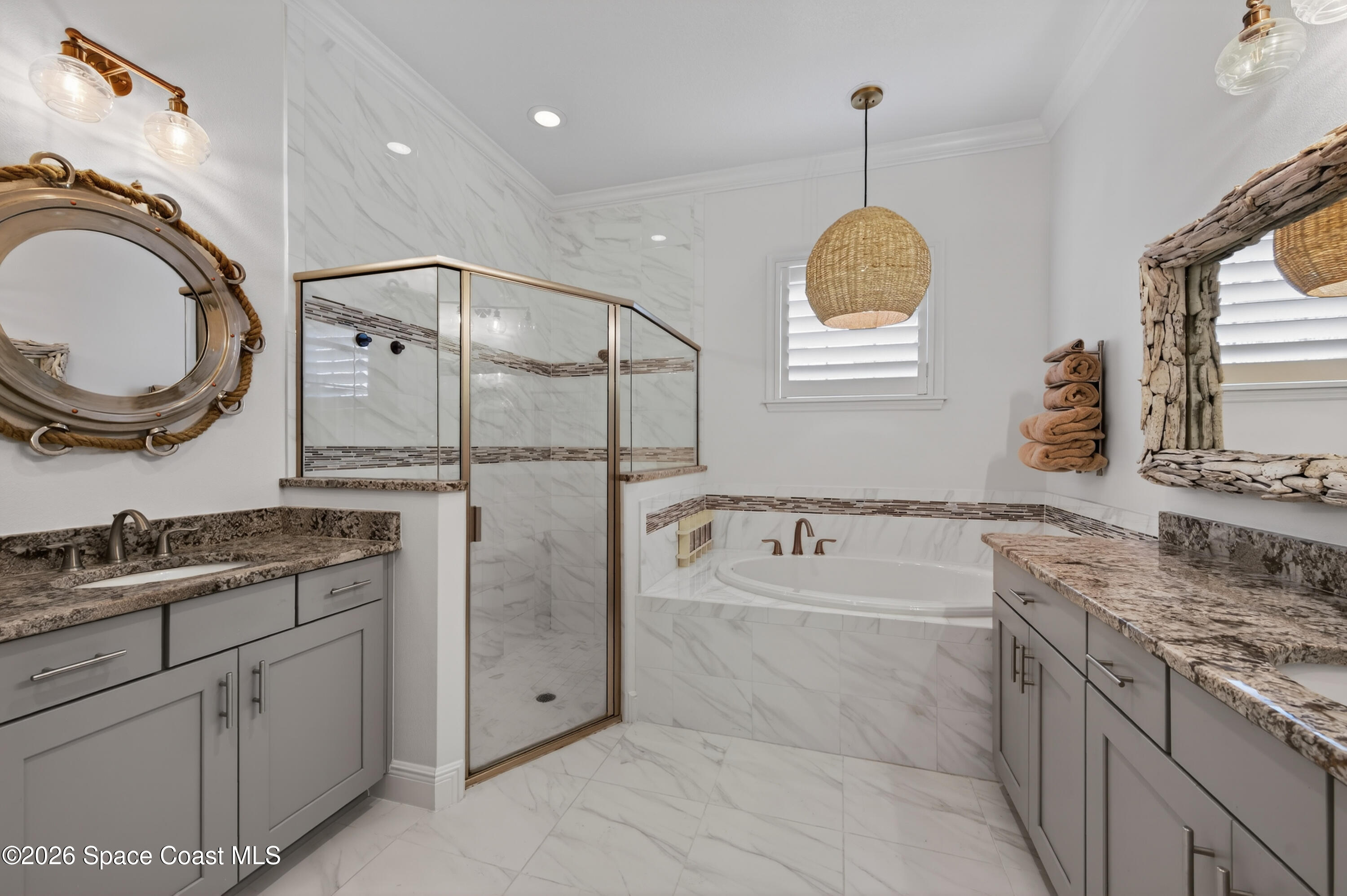 2343 Rodina Drive Melbourne, FL 32940 - Photo 23 of 72 a spacious bathroom with a granite countertop sink a mirror a vanity and a bathtub