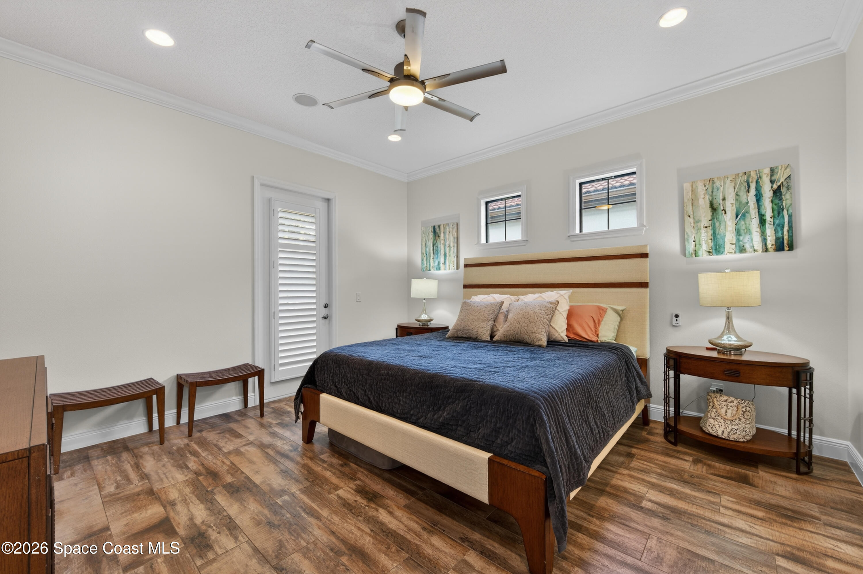 2343 Rodina Drive Melbourne, FL 32940 - Photo 25 of 72 a bedroom with a bed and a lamp on table
