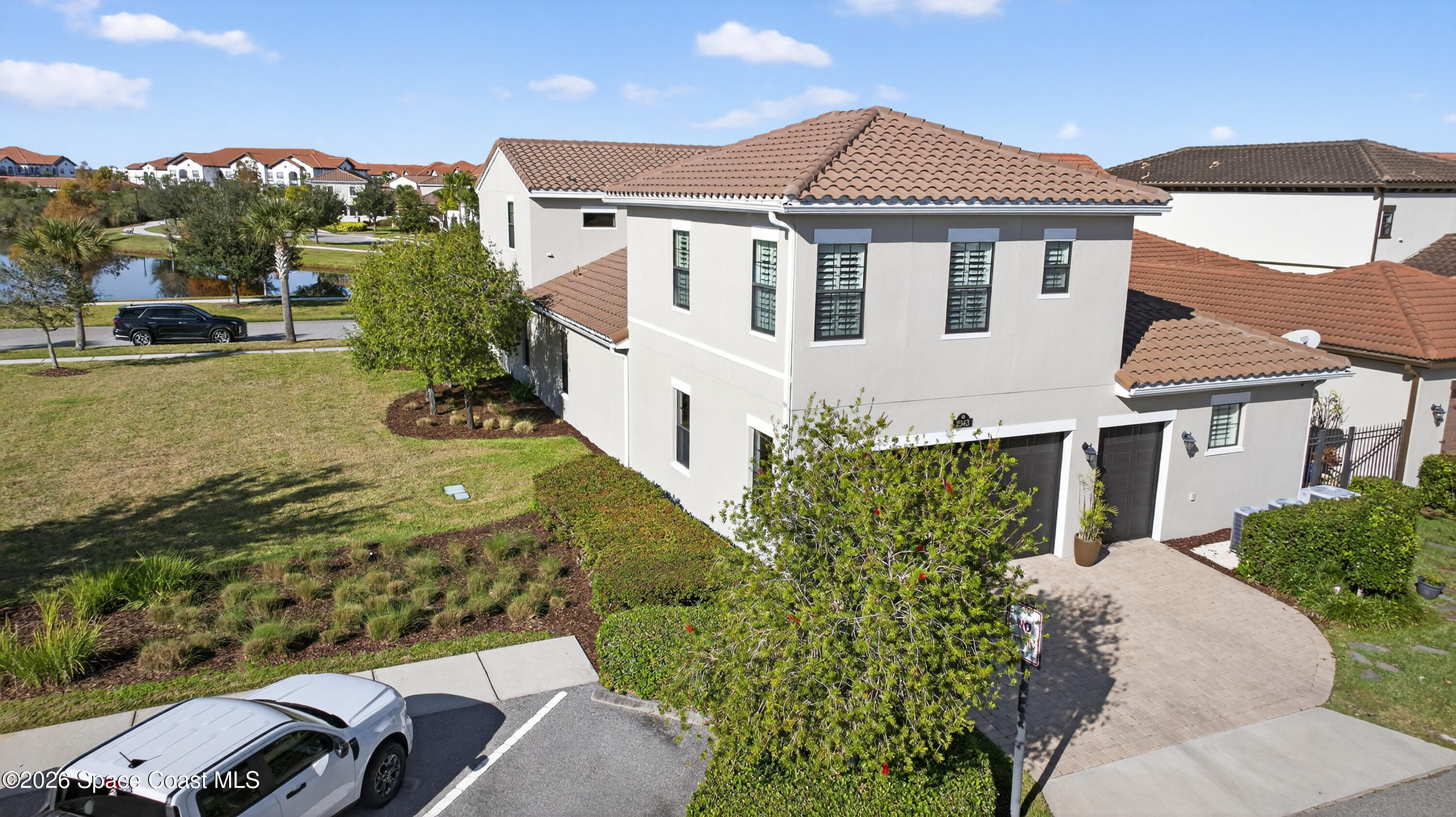 2343 Rodina Drive Melbourne, FL 32940 - Photo 38 of 72 a view of a white house with a yard