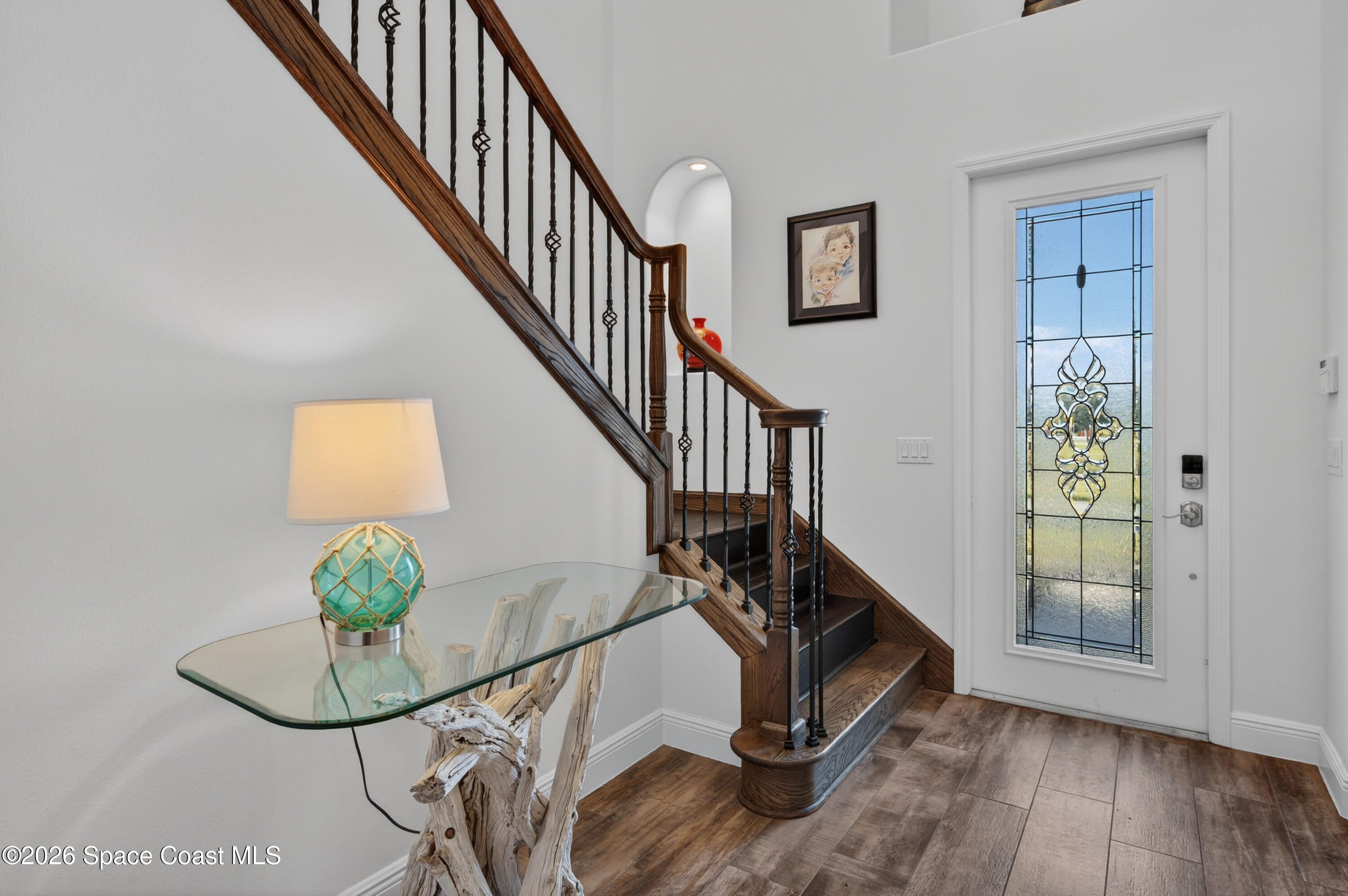 2343 Rodina Drive Melbourne, FL 32940 - Photo 57 of 72 a view of entryway with wooden floor and front door