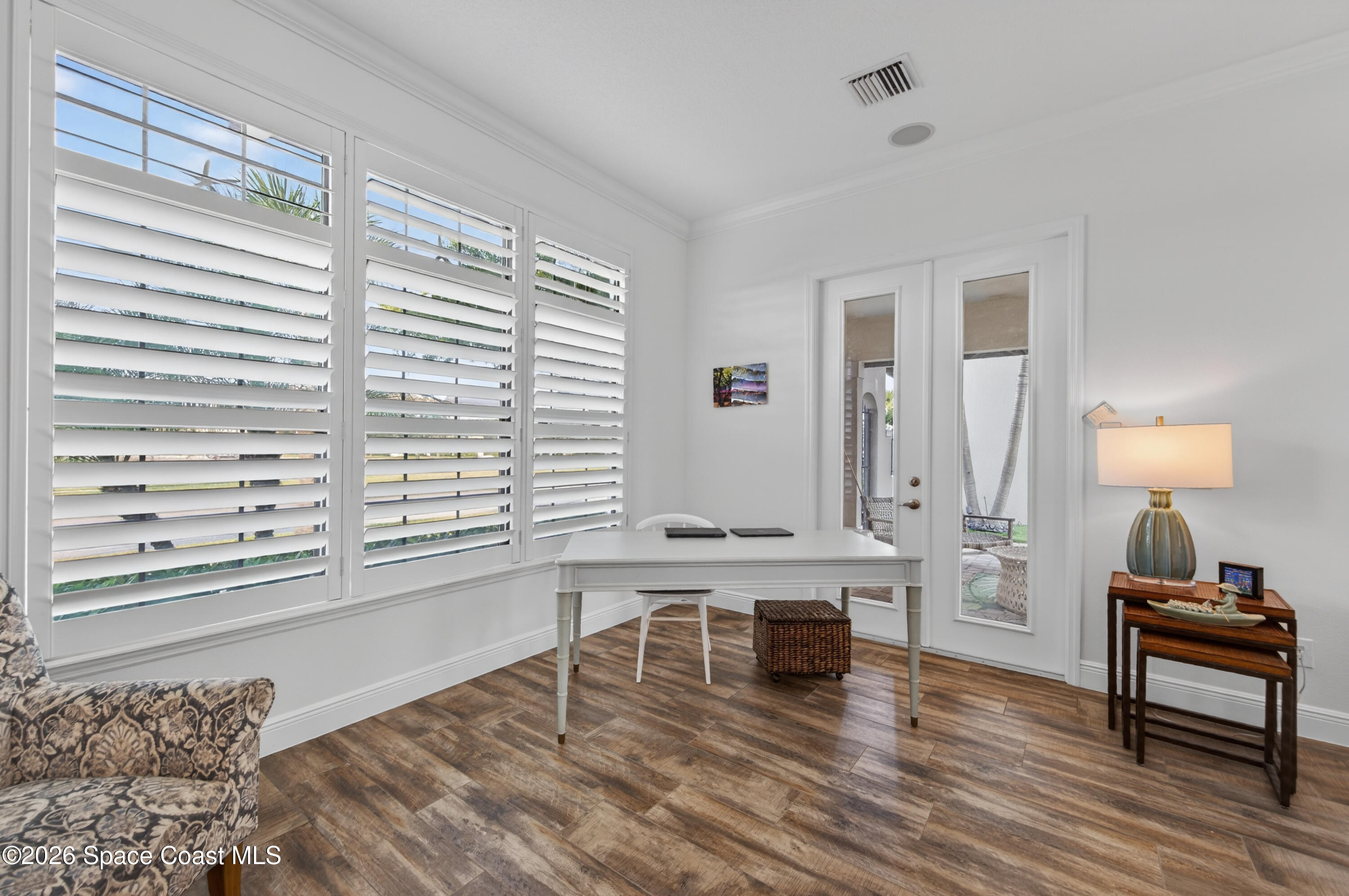 2343 Rodina Drive Melbourne, FL 32940 - Photo 61 of 72 a living room with a table and a large window