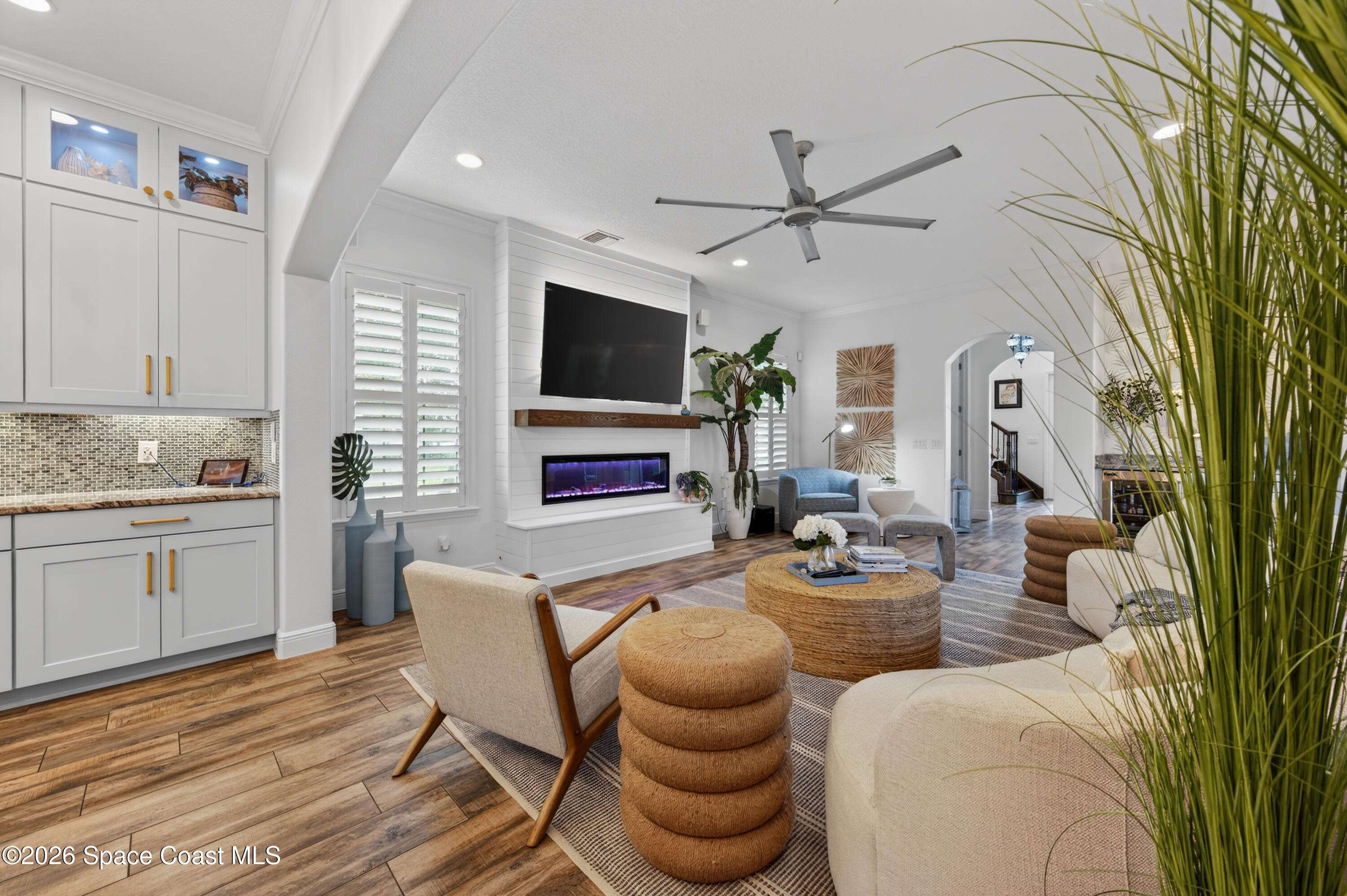2343 Rodina Drive Melbourne, FL 32940 - Photo 64 of 72 a living room with furniture a flat screen tv and kitchen view