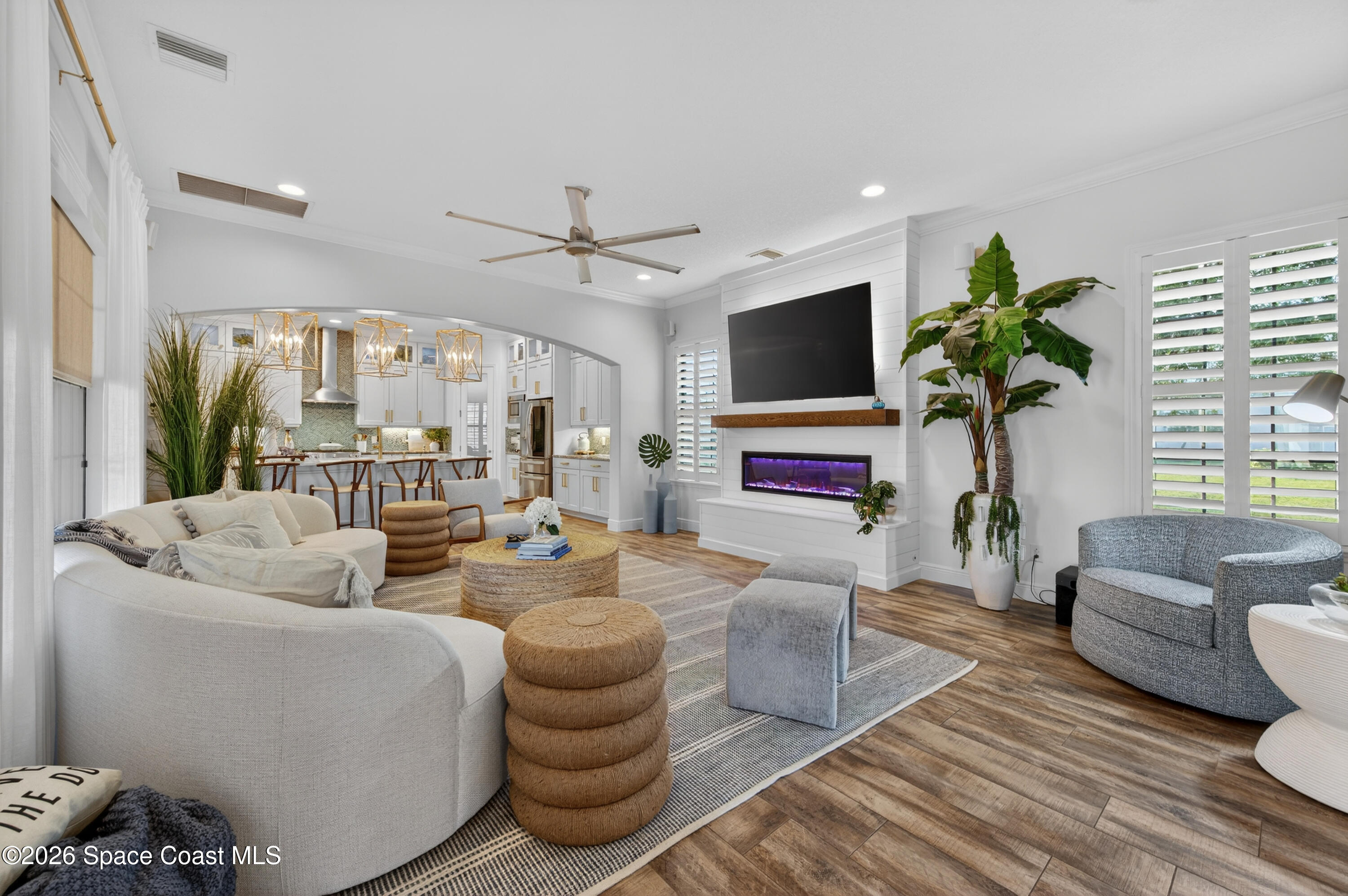 2343 Rodina Drive Melbourne, FL 32940 - Photo 66 of 72 a living room with furniture a flat screen tv and a large window