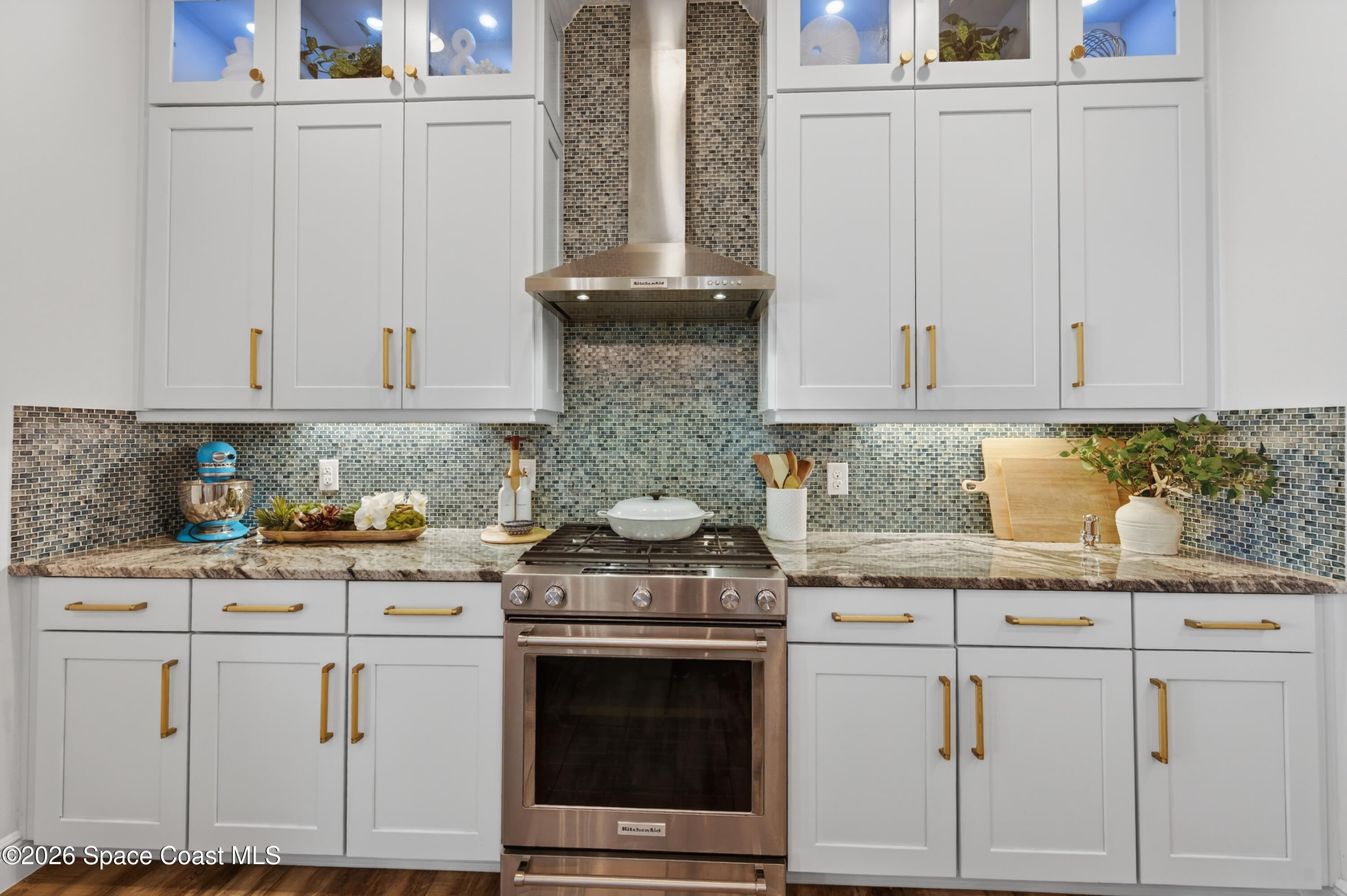 2343 Rodina Drive Melbourne, FL 32940 - Photo 69 of 72 a kitchen with granite countertop white cabinets and white appliances