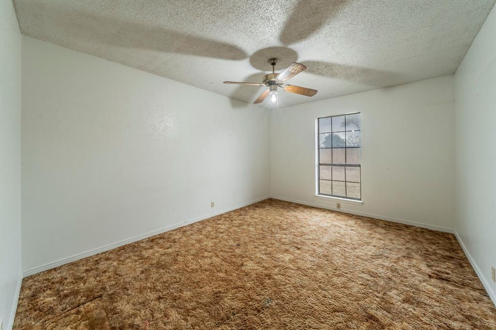 1202 Panorama Loop Waxahachie, TX 75165 - Photo 15 of 26 Carpeted empty room featuring a textured ceiling and baseboards