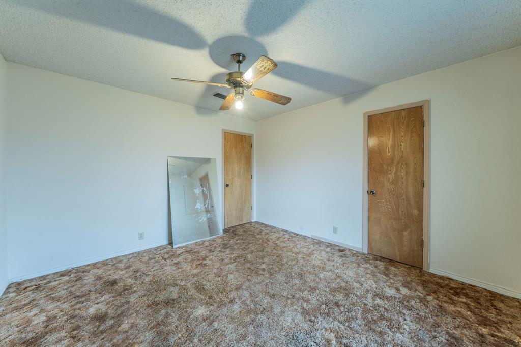 1202 Panorama Loop Waxahachie, TX 75165 - Photo 18 of 26 Unfurnished bedroom with carpet, a textured ceiling, a ceiling fan, and a closet