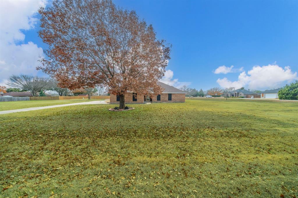 1202 Panorama Loop Waxahachie, TX 75165 - Photo 21 of 26 View of front of property featuring a front lawn and brick siding