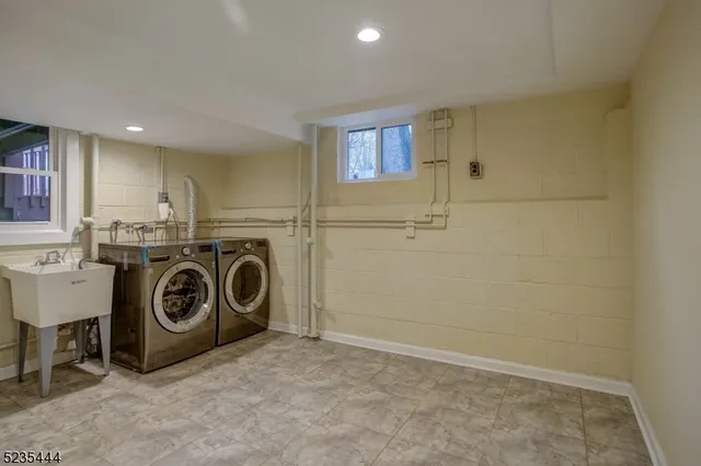 a utility room with sink dryer and washer