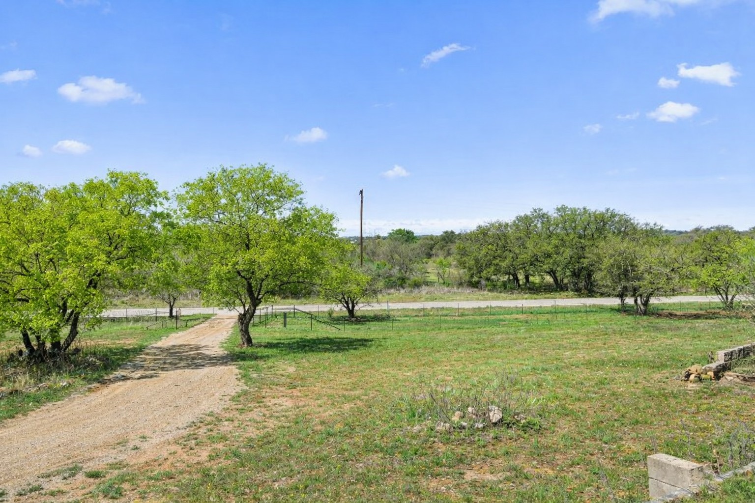 3410 West Ranch Road 152 Llano, TX 78643 - Photo 32 of 36 a backyard of a house with a yard and outdoor seating