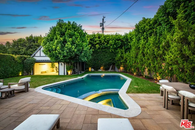 a kitchen with stainless steel appliances granite countertop a stove a sink and a white cabinets