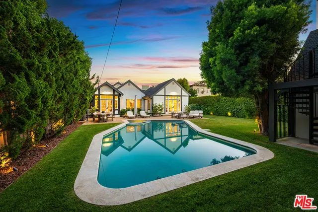 a living room with furniture and floor to ceiling windows