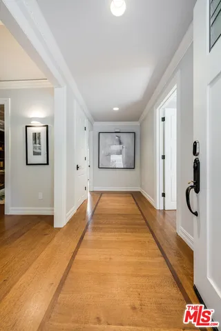 a kitchen with stainless steel appliances kitchen island granite countertop lots of white furniture a sink a stove and a refrigerator