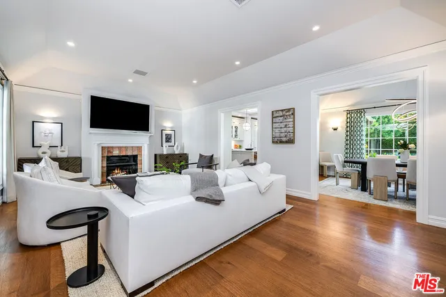 a kitchen with sink stove and wooden floor