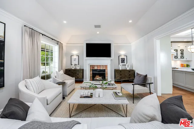 a kitchen with a stove a sink a dining table and chairs