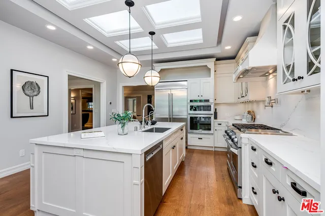 a bathroom with a tub a sink a mirror and a shower