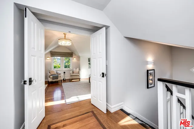 a large bed sitting in a bedroom next to a window