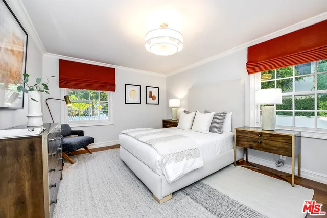 a bedroom with a large bed and a large window