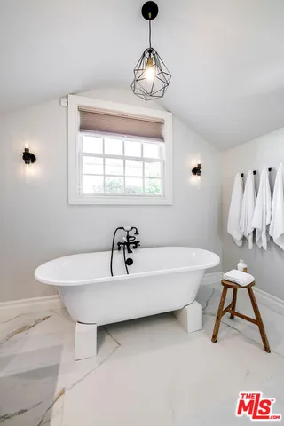 an aerial view of a house with a garden and outdoor seating