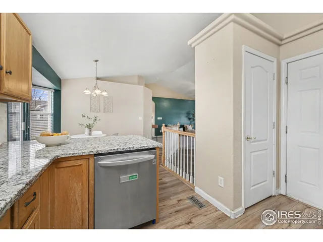 a kitchen with stainless steel appliances granite countertop wooden cabinets a sink and dishwasher