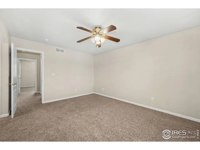a view of a room with a ceiling fan and a window