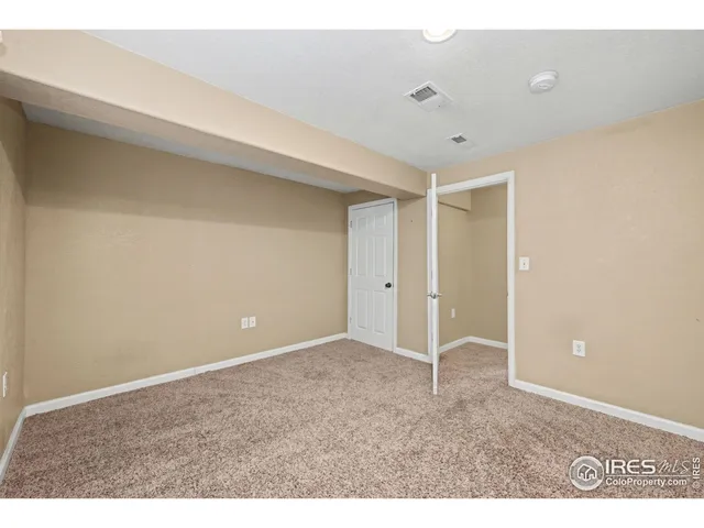 a utility room with stainless steel appliances a sink and a refrigerator