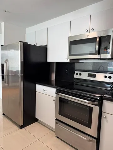 a kitchen with a refrigerator and a sink
