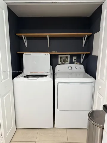 a spacious bathroom with a double vanity sink toilet mirror and a shower