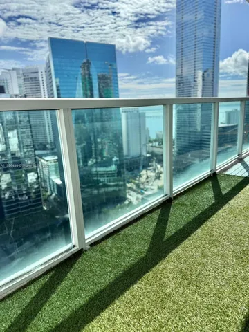 a view of balcony with a small yard