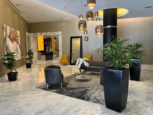 a living room with furniture rug and wooden floor