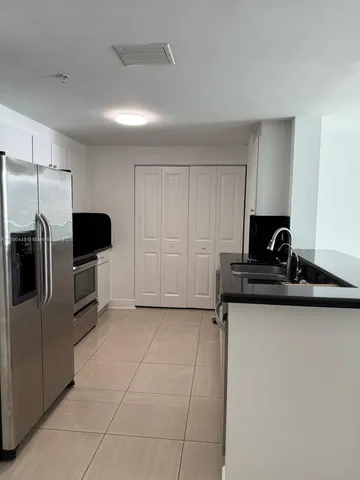 a kitchen with kitchen island a counter space and appliances