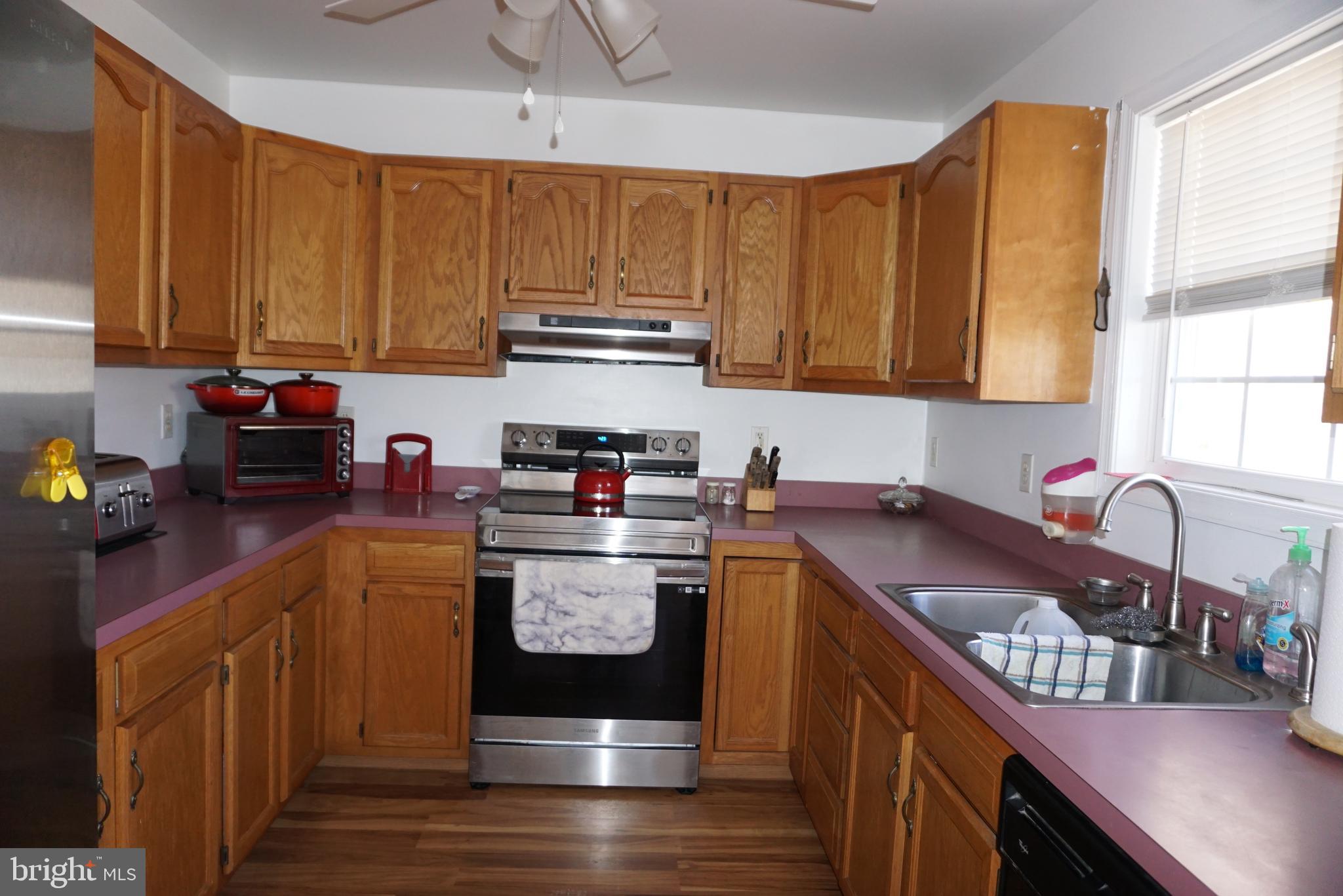 1001 Nottingham Road Elkton, MD 21921 - Photo 9 of 20 a kitchen with kitchen island granite countertop a sink cabinets and stainless steel appliances