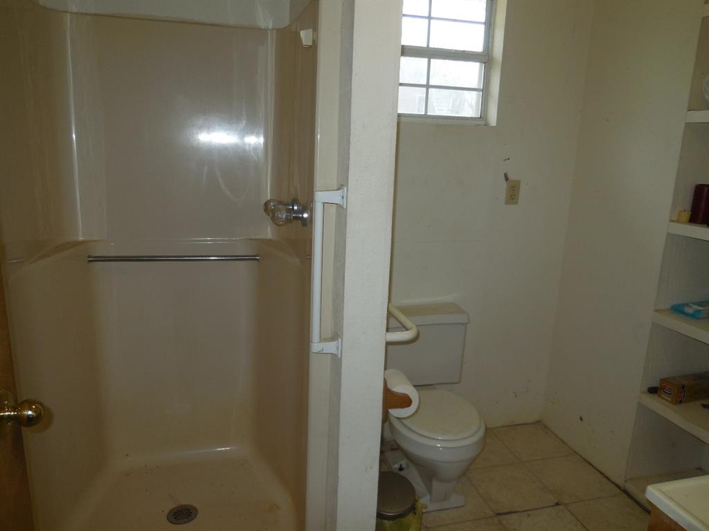910 Sinclair Street Ranger, TX 76470 - Photo 16 of 21 a bathroom with a toilet and a shower